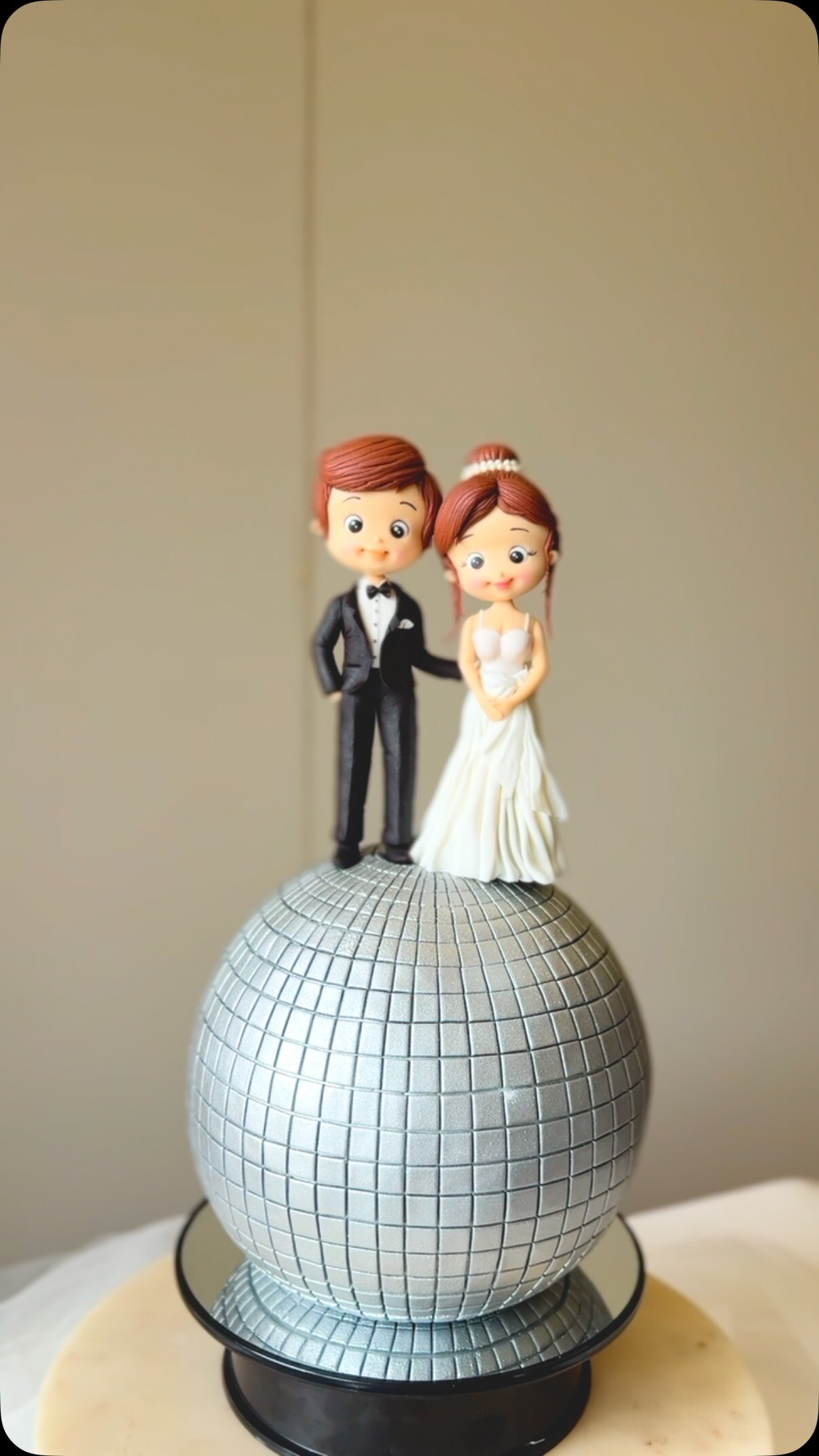 Disco ball wedding cake with bride and groom topper